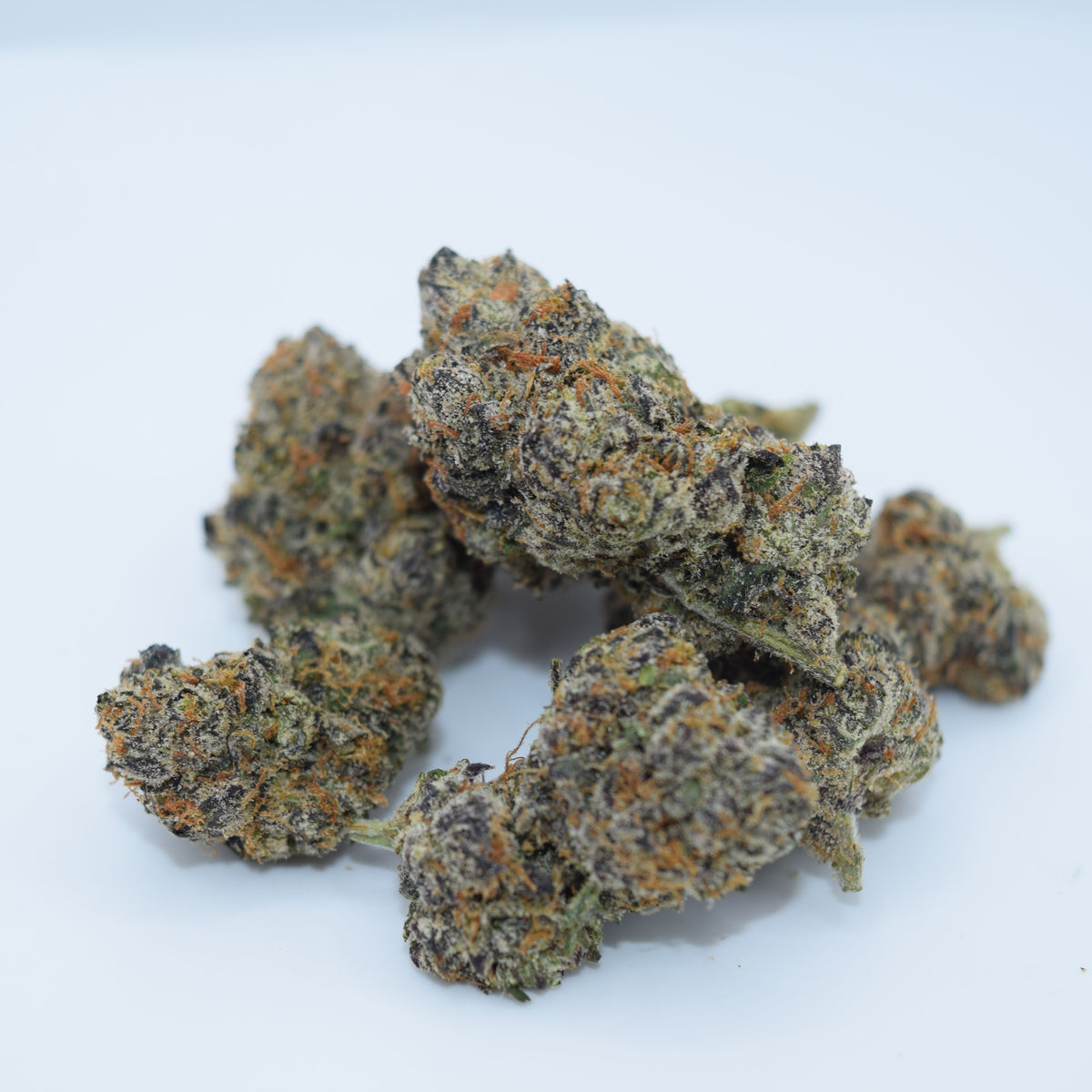 Black Magic Craft THCa flower with dark purple-black resinous buds and a rich berry, grape, citrus, earthy spice, and woody aroma profile.