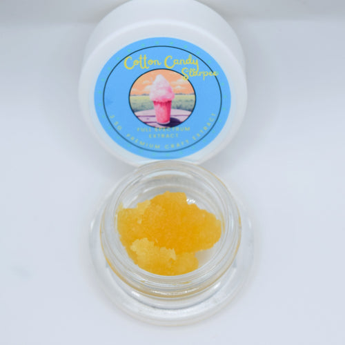 Cotton Candy Slurpee THCa live resin with glossy golden terpene-rich extract featuring sweet cotton candy, berry, citrus, and creamy vanilla aroma profile.