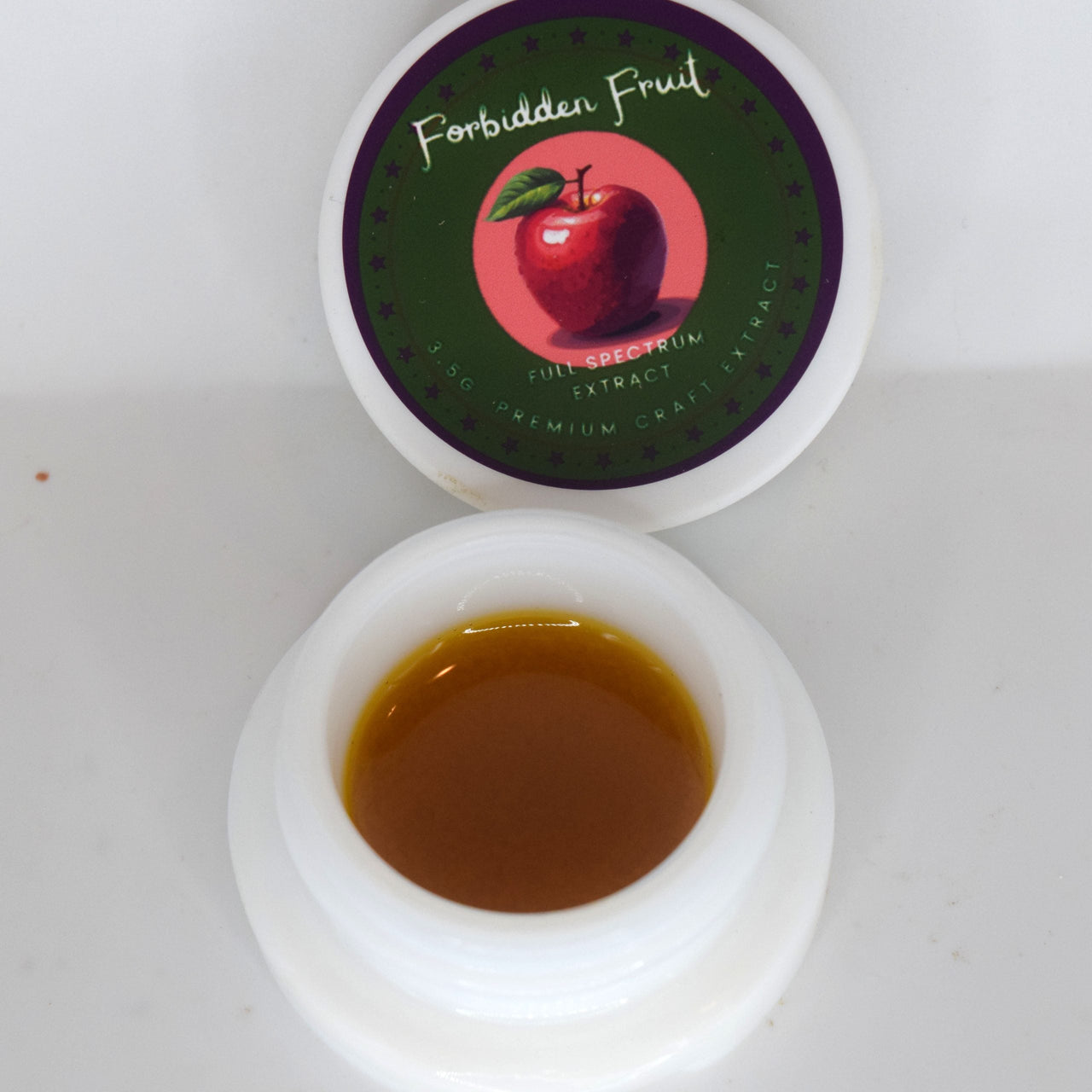 Forbidden Fruit THCa wet badder showing creamy golden extract with tropical fruit and cherry terpene profile.