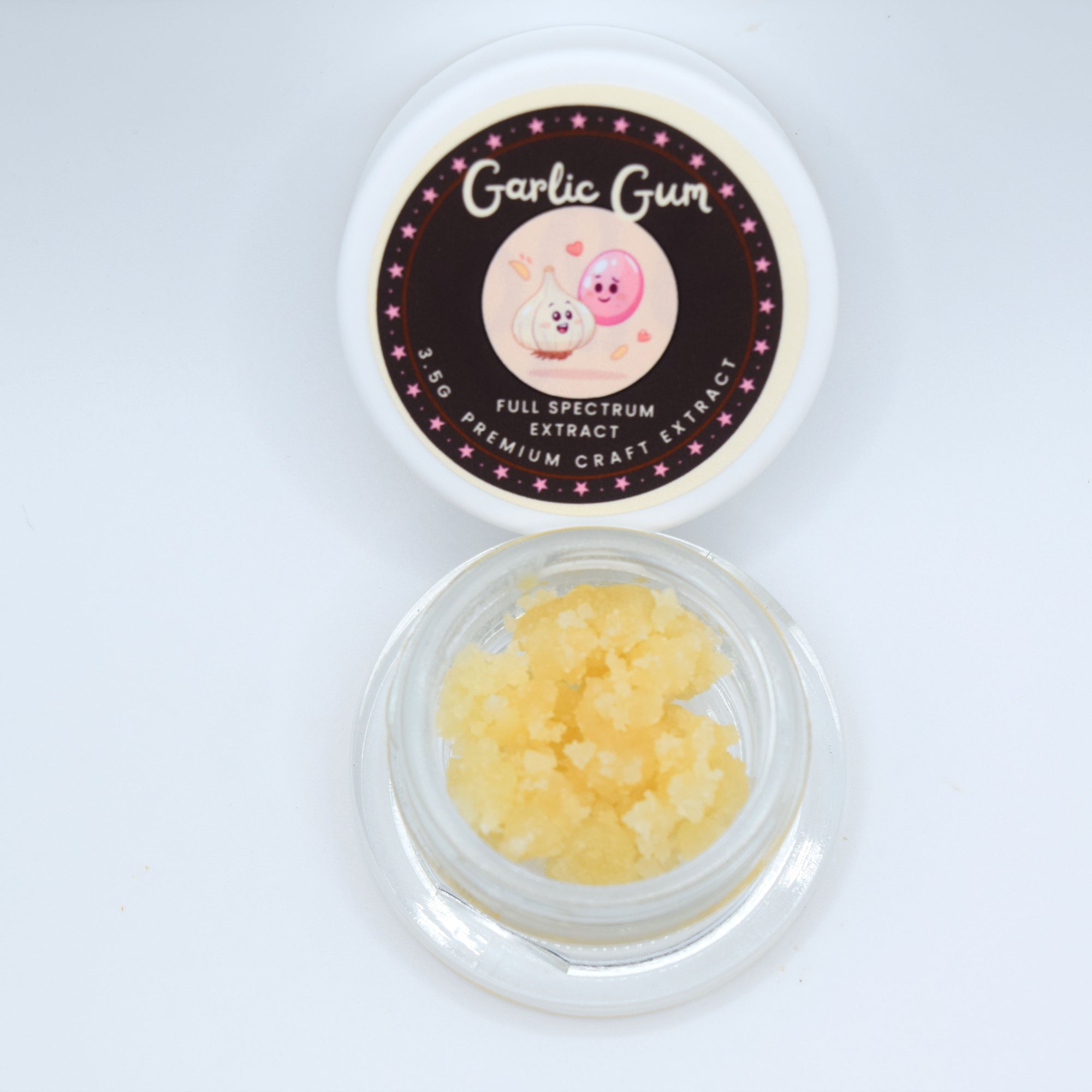 A small clear jar filled with pale yellow crystalline garlic gum, shown below its white lid which features a dark brown circular label reading 'Garlic Gum' and 'Full Spectrum Craft Extract'.
