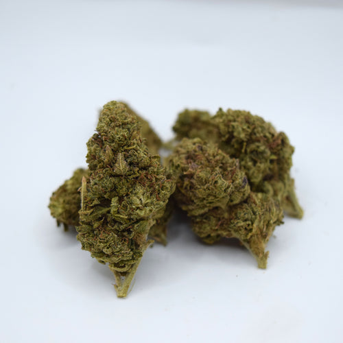 Three dried cannabis buds with green and brown hues, clustered together on a plain white background.