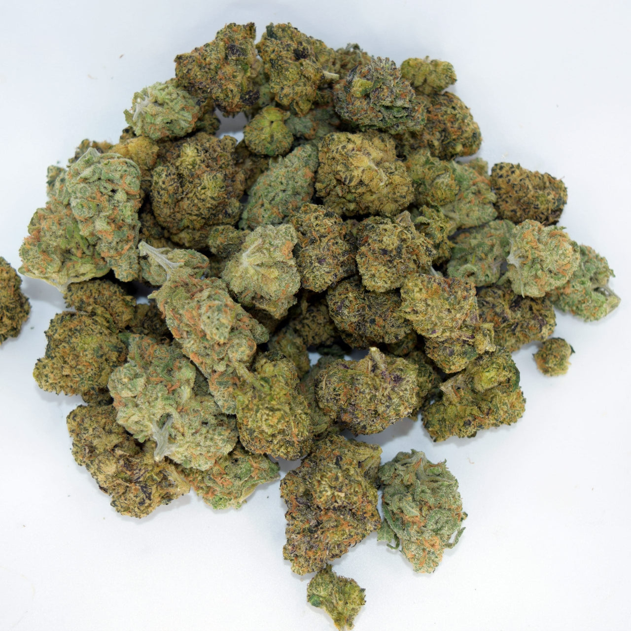 Mixed exotic ounce with multiple colorful strains in a single 28g bag, showing diverse nug structures and trichome frost.