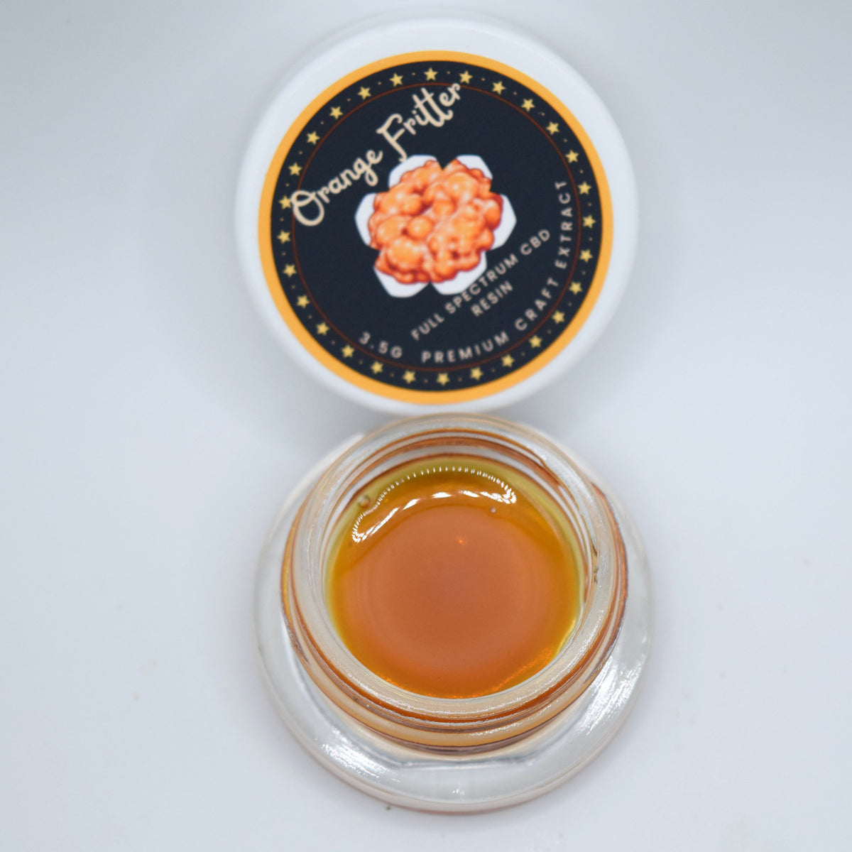 Orange Fritter craft CBD full spectrum extract featuring a darker, thick resin consistency with a citrus-forward orange and diesel profile.
