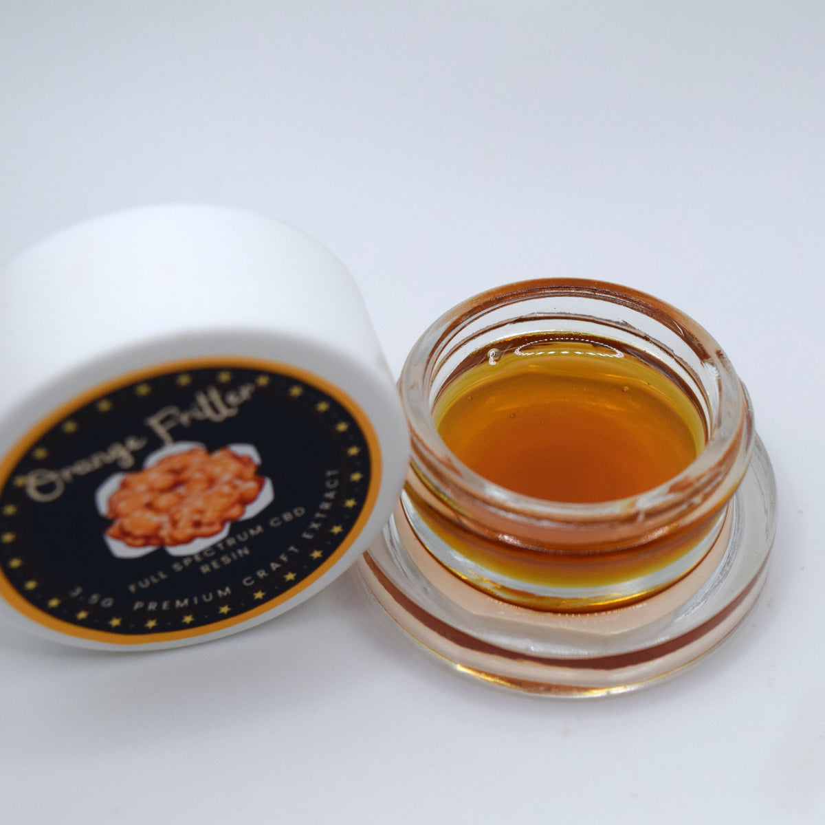 Orange Fritter craft CBD full spectrum extract featuring a darker, thick resin consistency with a citrus-forward orange and diesel profile.