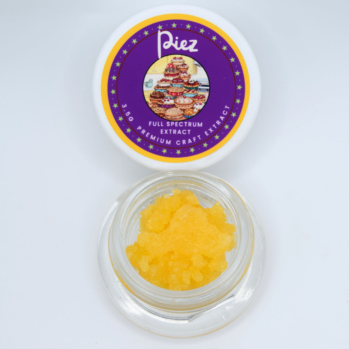 A small clear jar filled with bright yellow crystalline powder sits below its white lid, which features a purple and gold circular label reading 'Piez Full Spectrum Extract Premium Craft Extract'.