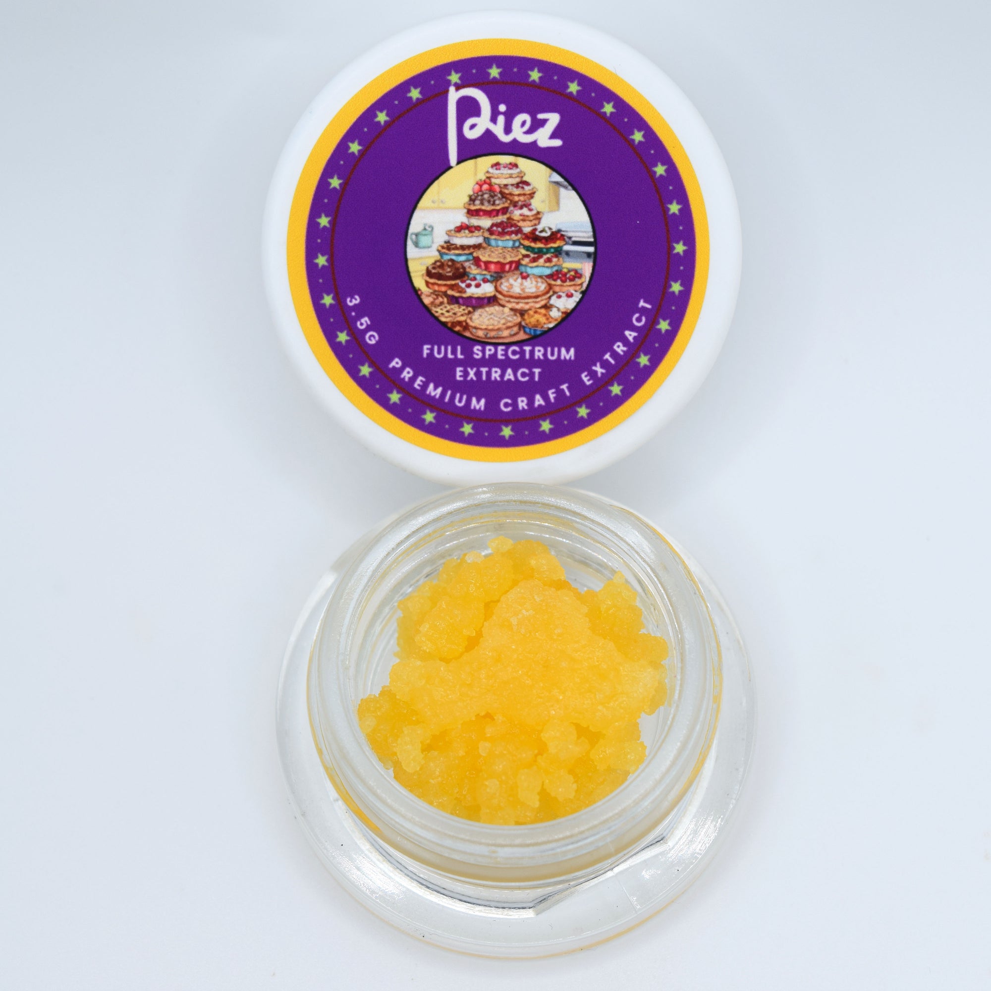 A small clear jar filled with bright yellow crystalline powder sits below its white lid, which features a purple and gold circular label reading 'Piez Full Spectrum Extract Premium Craft Extract'.