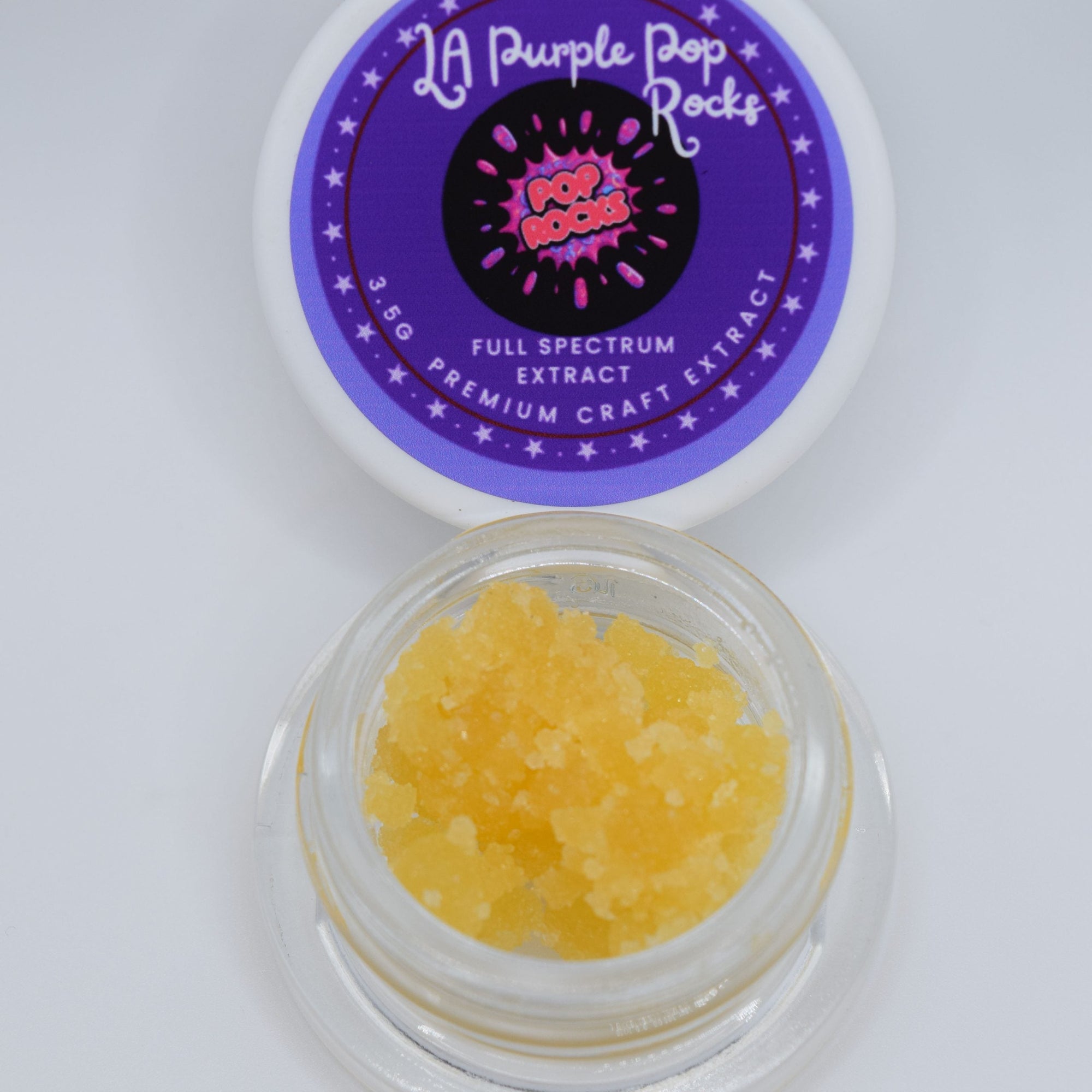 Purple LA Pop Rocks THCa full spectrum extract with golden amber consistency and sweet grape candy gas aroma profile.