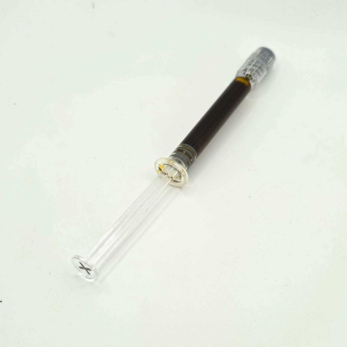 A clear glass test tube with a dark brown liquid inside and a silver screw cap, shown on a plain white background.