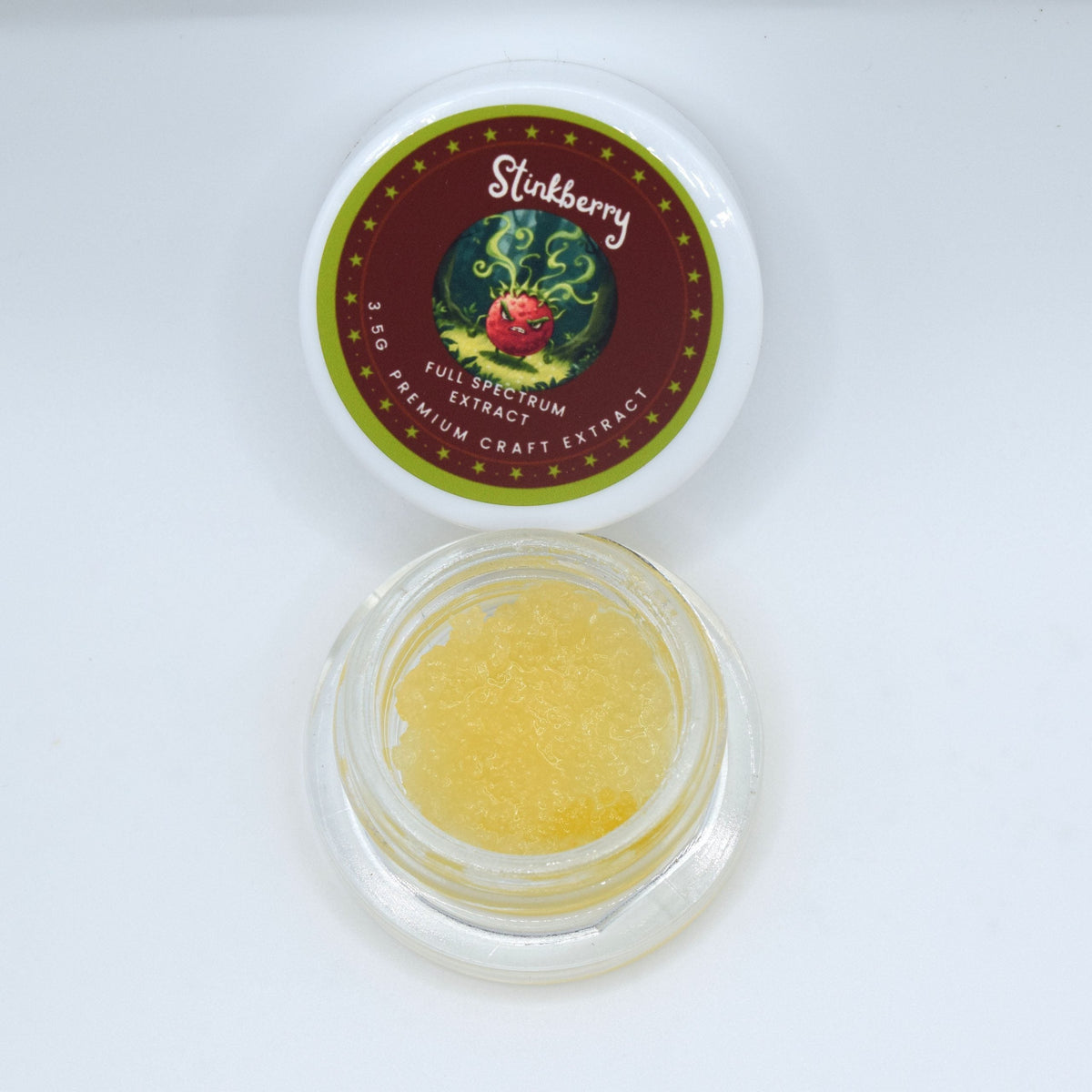 Stinkberry live THCa full spectrum extract showing golden terpene-rich resin with floral, berry, and woody forest aroma characteristics.