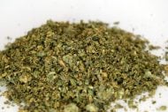 Bag of mixed THCa flower shake in 28g format with trichome-coated flakes and small popcorn nugs.