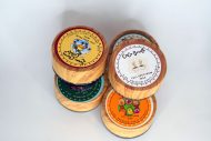 Golden full spectrum wax with waxy crumble texture in a bulk container, labeled Mixed Strains.
