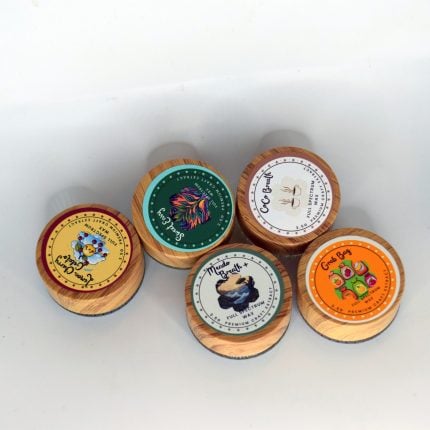 Golden full spectrum wax with waxy crumble texture in a bulk container, labeled Mixed Strains.