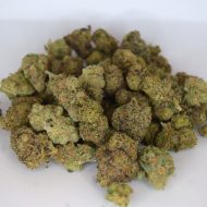 Mixed exotic ounce with multiple colorful strains in a single 28g bag, showing diverse nug structures and trichome frost.