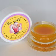 Amber Sour Gelato full spectrum extract in glass jar with waxy sugar texture labeled “Sour Gelato FSE”.
