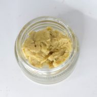Golden Mad Fruit live hash rosin in jar with glossy terpene-rich texture labeled “S-Tier Live Rosin”.