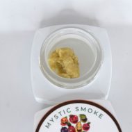 Golden Mad Fruit live hash rosin in jar with glossy terpene-rich texture labeled “S-Tier Live Rosin”.