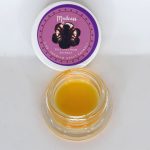Amber Madness THCa HTFSE sauce with rich terpene oil and glossy texture labeled “Madness HTFSE.”