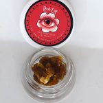 Golden unfiltered Red Eye THCa live resin with saucy texture and terpene sheen.