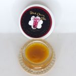 Black Cherry Soda THCa full spectrum sugar showing golden crystals with terpene-rich sauce in glass container.