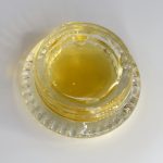Vape-ready THCa liquid diamonds with HTFSE showing clear golden oil and terpene-rich consistency in glass container.