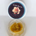 Gelato Sunrise THCa full spectrum sugar showing golden crystals with terpene-rich sauce in glass container.