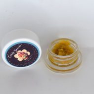 Gelato Sunrise THCa full spectrum sugar showing golden crystals with terpene-rich sauce in glass container.