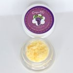 Grape OG THCa full spectrum extract showing amber terpene sauce with crystalline THCa and resin sheen.