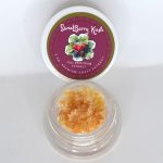 Sweetberry Kush THCa full spectrum extract showing berry-toned terpene sauce with caviar sugar crystalline texture.