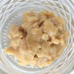 Tropicana Cherry live hash rosin 73–90u showing light blonde cold-cured rosin with creamy texture in glass jar.