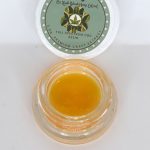 OZ Kush CBD full spectrum extract showing golden terpene-rich consistency with citrus and floral kush profile.