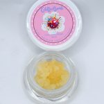 Glitter Bomb THCa full spectrum soft sugar showing golden crystalline extract with grape, blueberry, gas, and kush aroma profile.