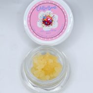 Glitter Bomb THCa full spectrum soft sugar showing golden crystalline extract with grape, blueberry, gas, and kush aroma profile.