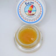 Kush Pop THCa wet sugar showing golden crystalline extract with glossy terpene sauce and citrus kush aroma profile.