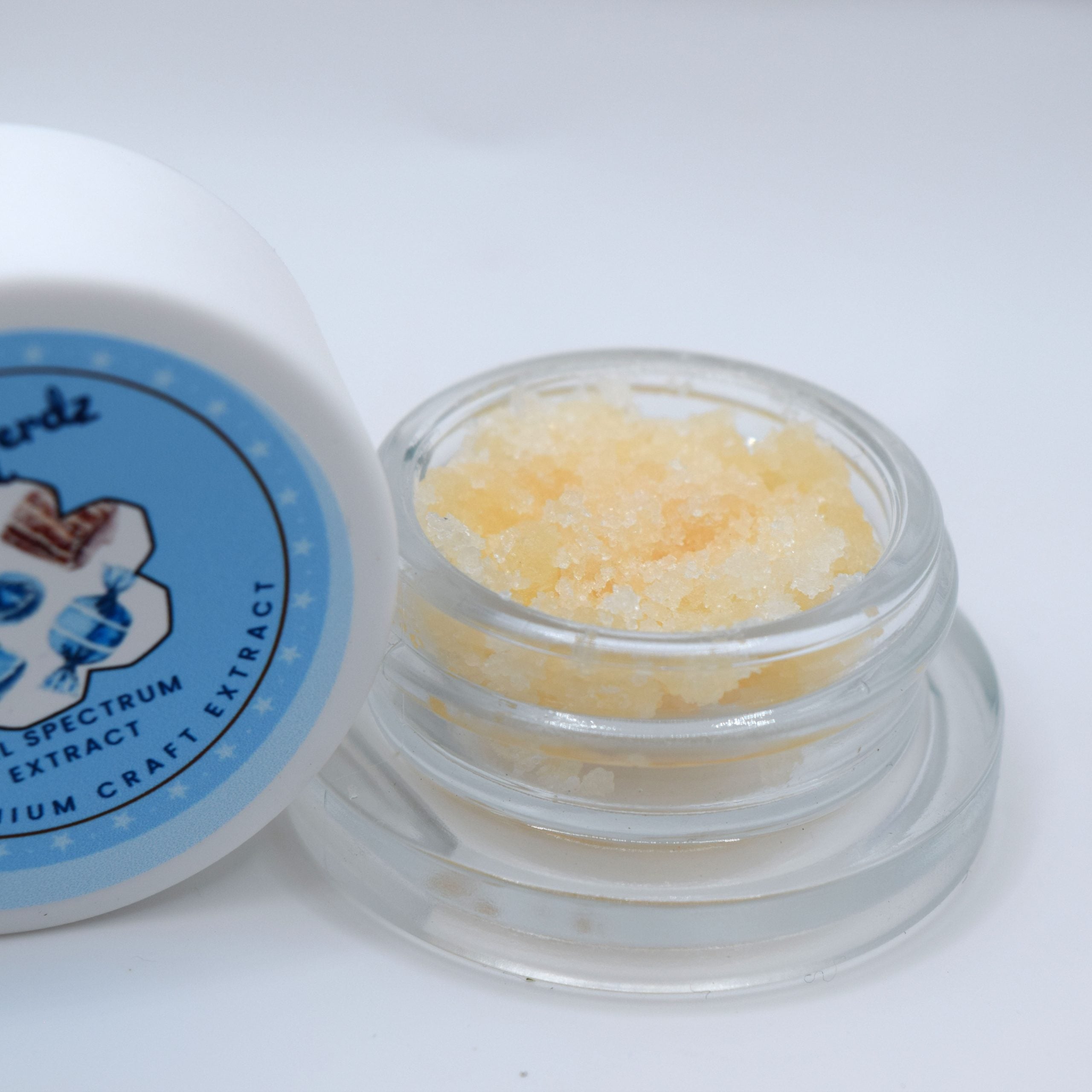 Blue Nerdz THCa live resin sugar showing golden crystals with terpene-rich sauce and blue candy berry profile.